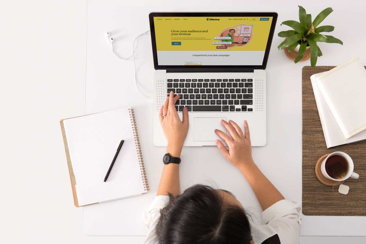 A lady pressing a laptop
