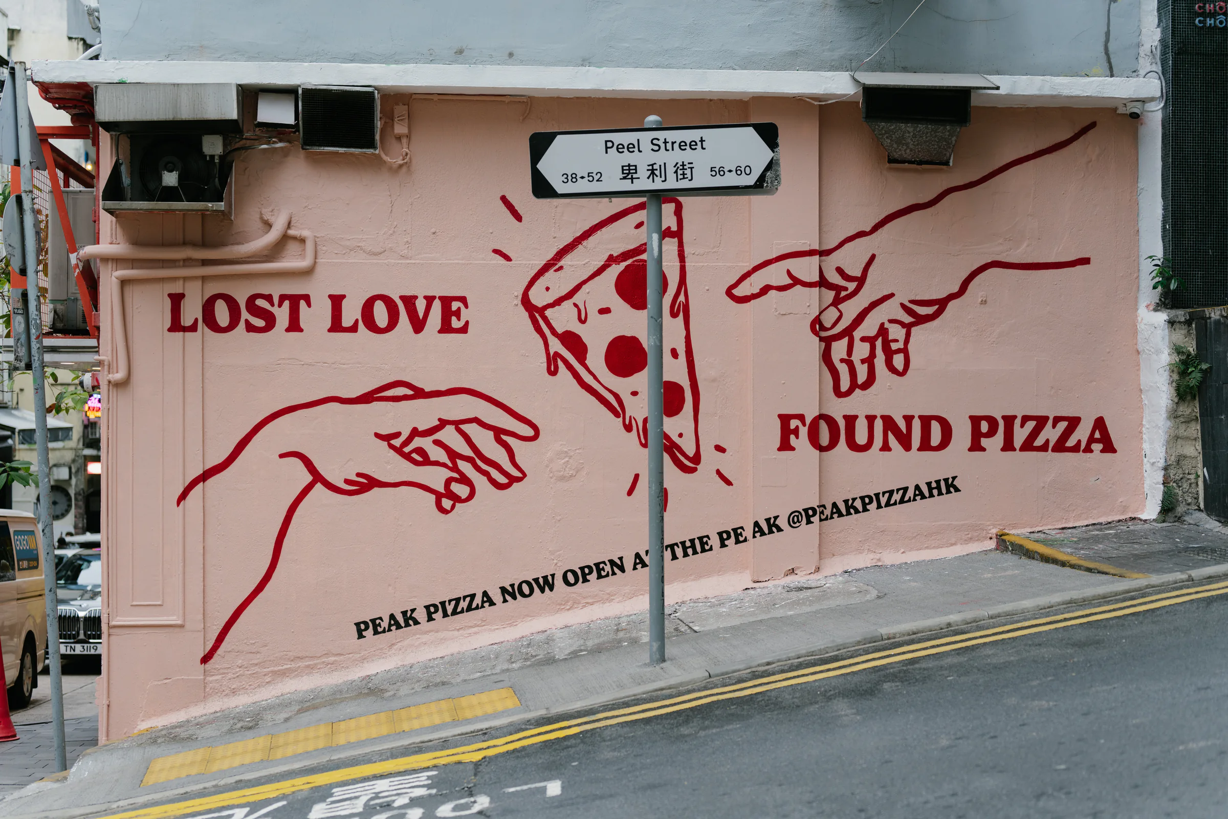 Hand-painted Lost Love Found Pizza mural on a city wall