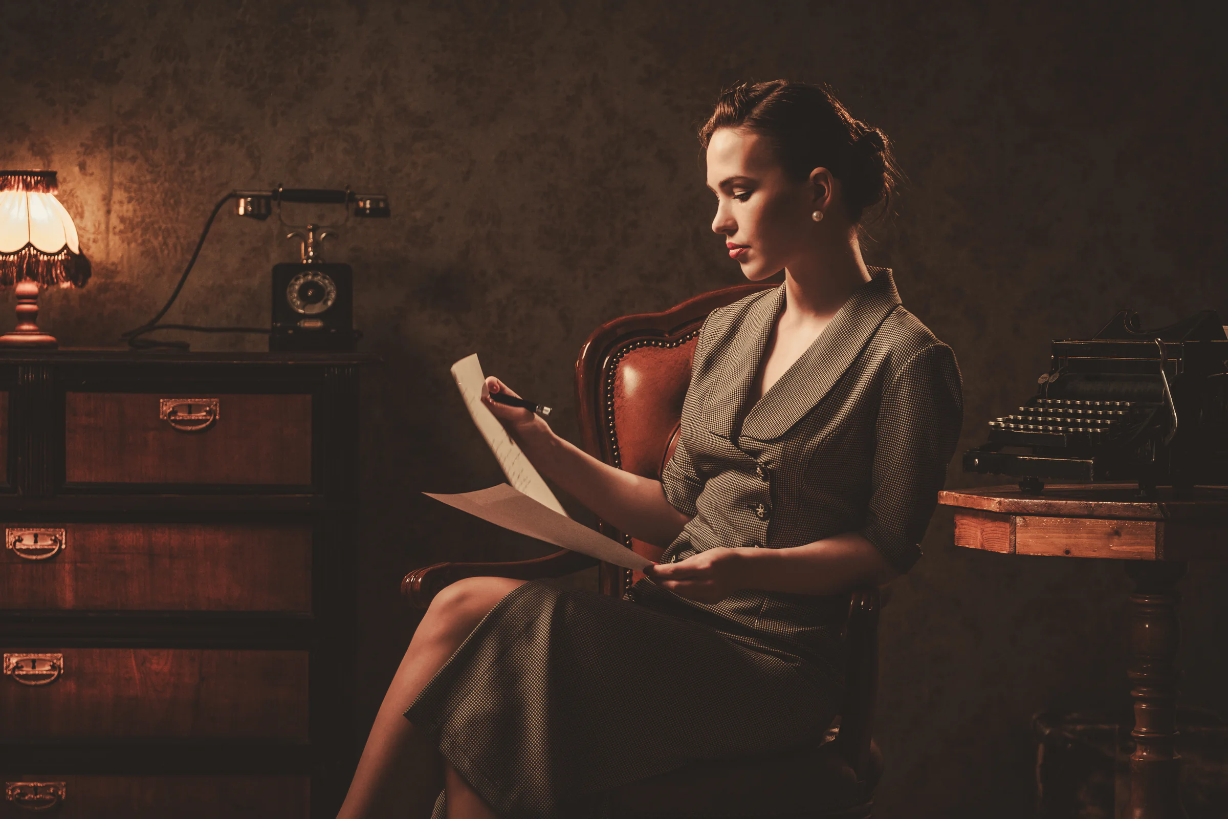 Woman reviewing documents in a vintage study