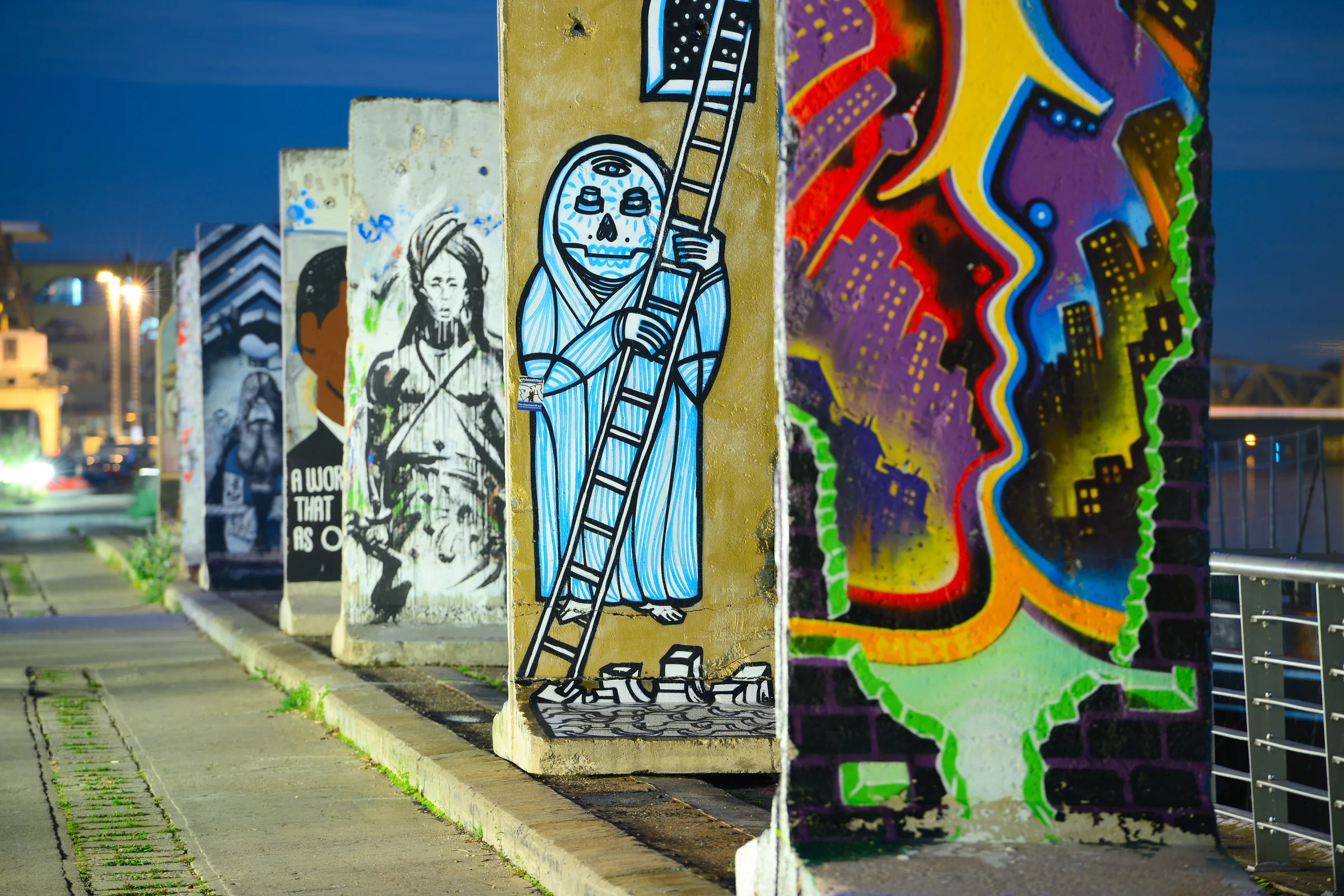 Colourful painted sections of the Berlin Wall at night