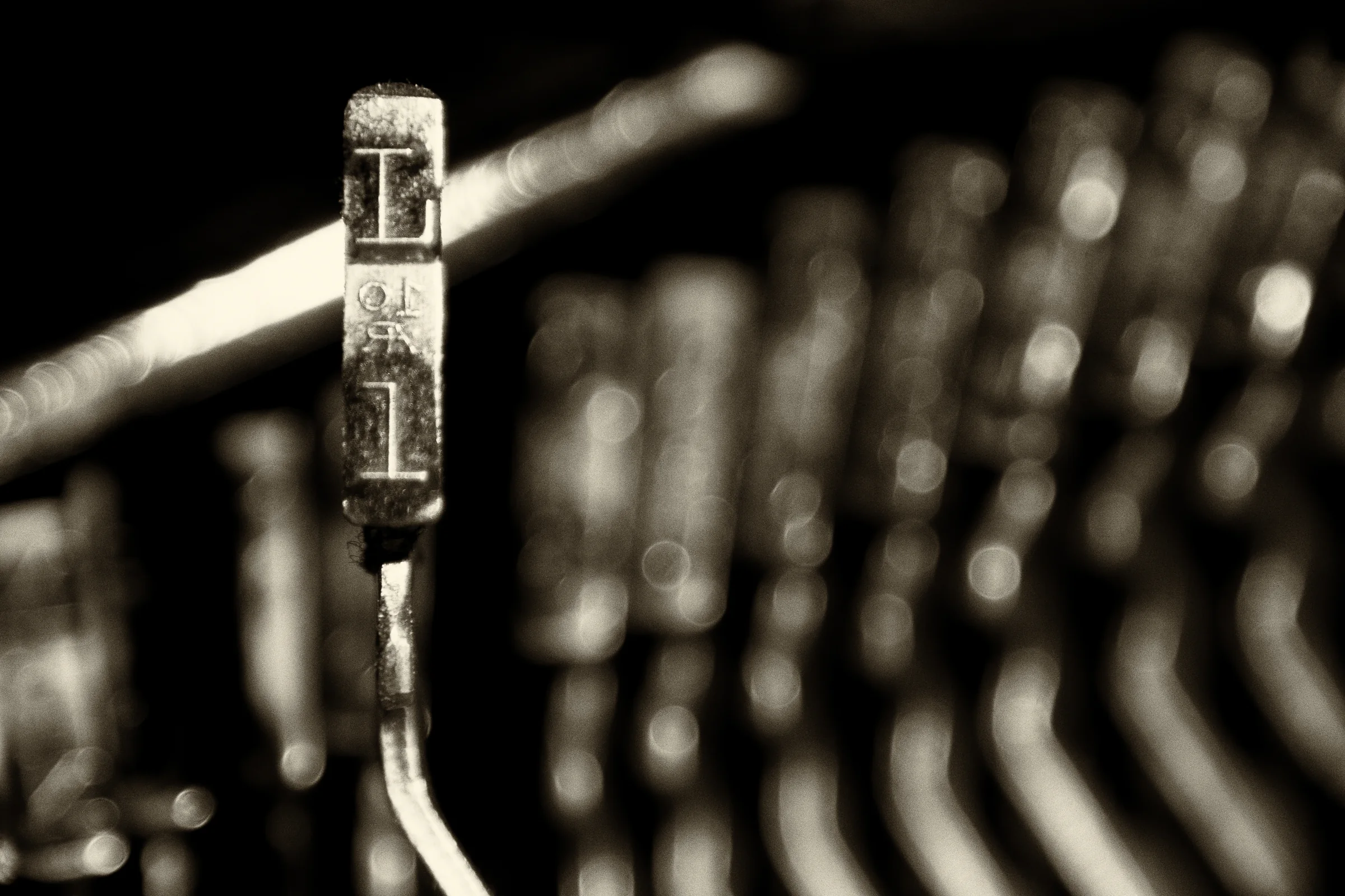 Close-up of the letter L key on a vintage typewriter