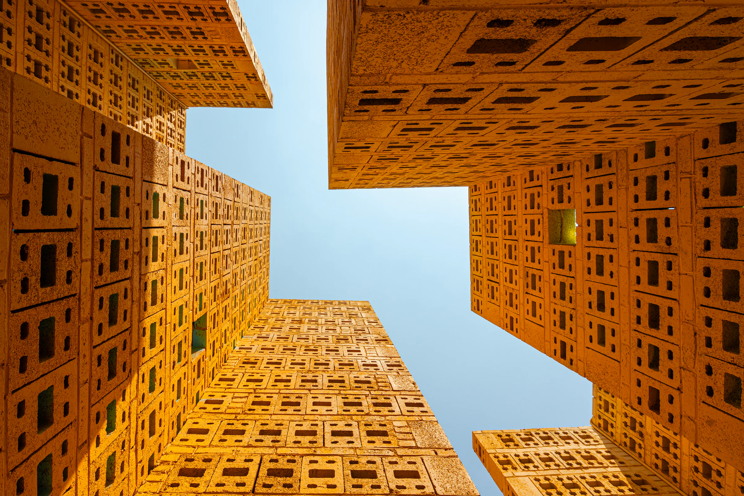 Modern buildings framing a clear blue sky
