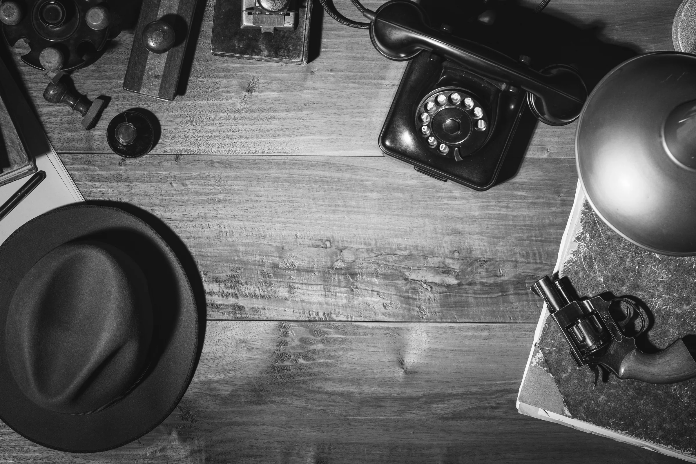Vintage detective desk with a telephone, hat and investigation notes