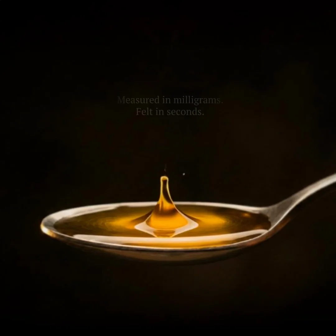 Golden olive-oil drop rising from a spoon in the Measured in Milligrams film